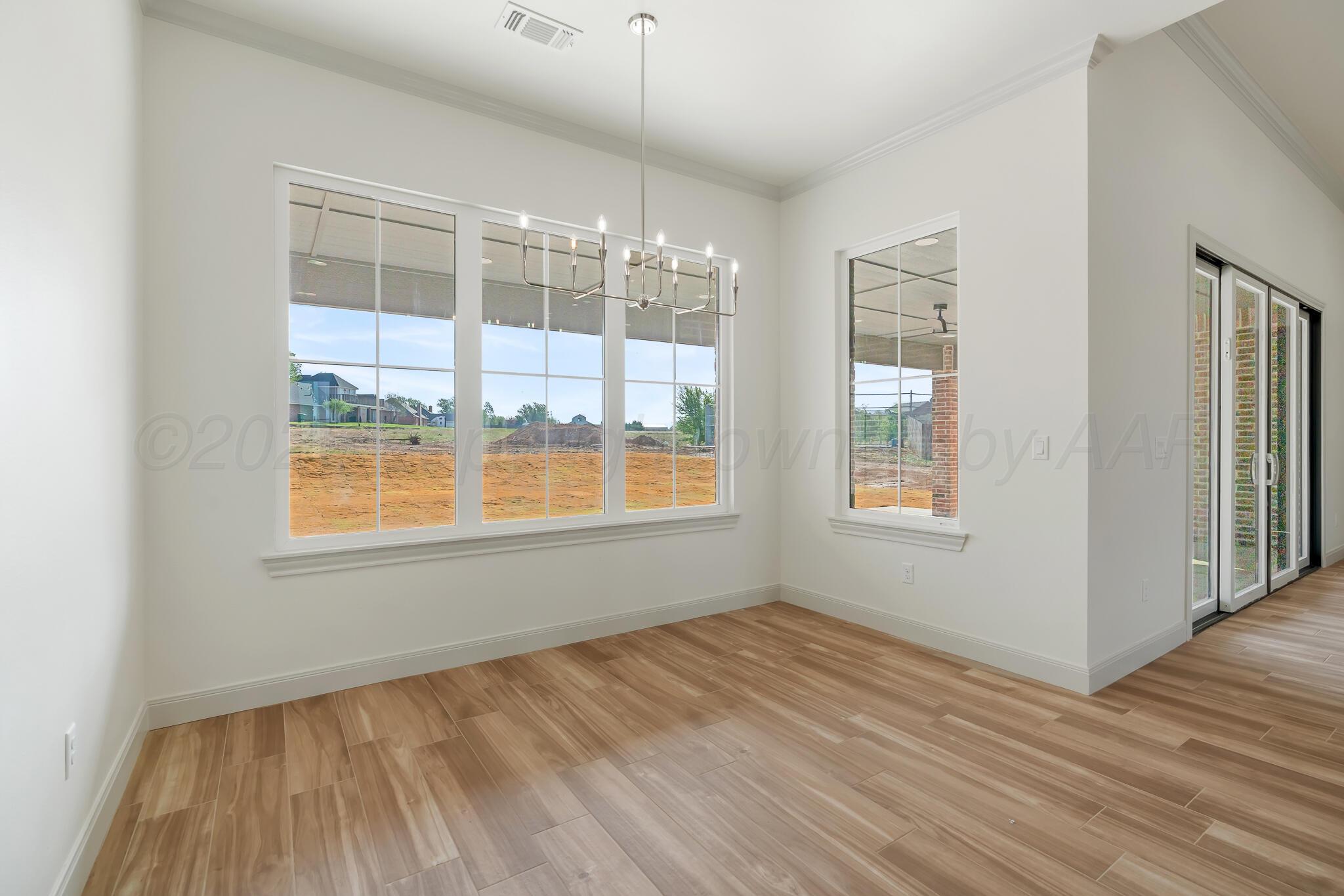 16551 Spring Lake Drive Canyon, TX 79015 - Photo 24 of 60 a view of an empty room with wooden floor and a window