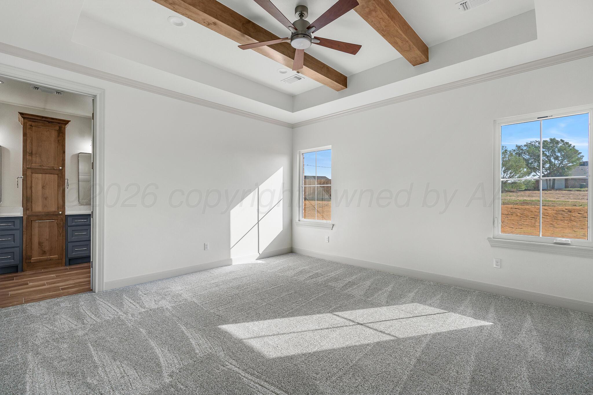 16551 Spring Lake Drive Canyon, TX 79015 - Photo 33 of 60 an empty room with windows and ceiling fan