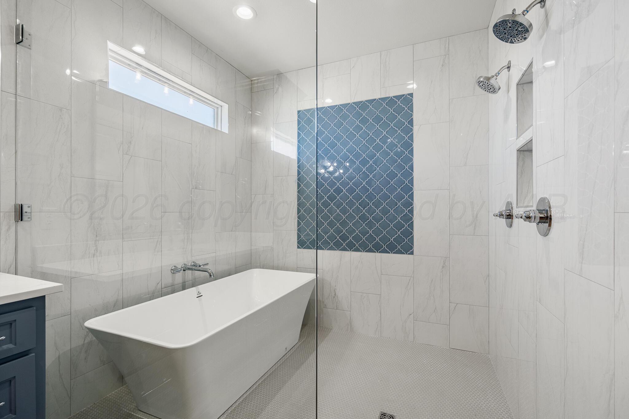 16551 Spring Lake Drive Canyon, TX 79015 - Photo 36 of 60 a bathroom with a sink a shower and a mirror