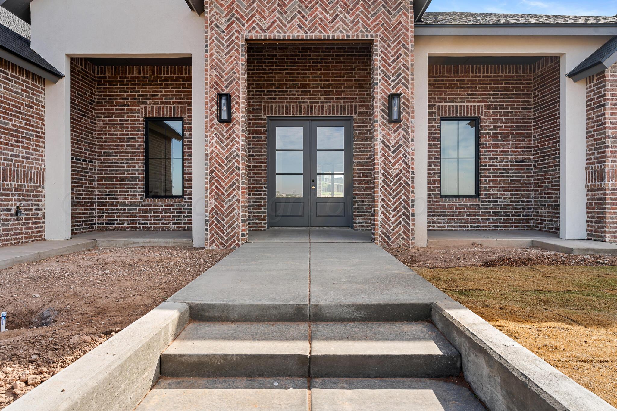 16551 Spring Lake Drive Canyon, TX 79015 - Photo 4 of 60 a view of a brick house with large windows