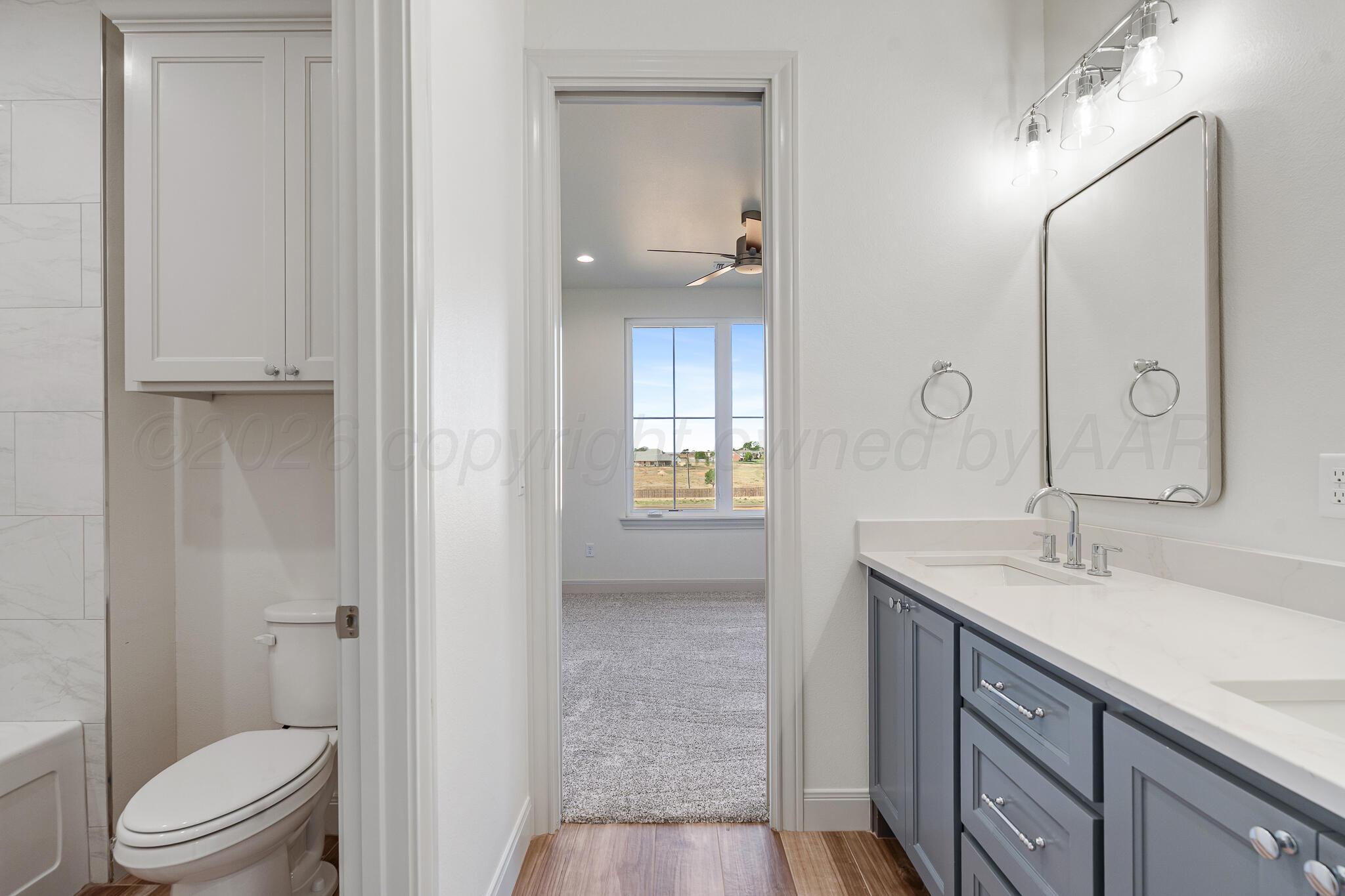 16551 Spring Lake Drive Canyon, TX 79015 - Photo 44 of 60 a bathroom with a sink a toilet and shower