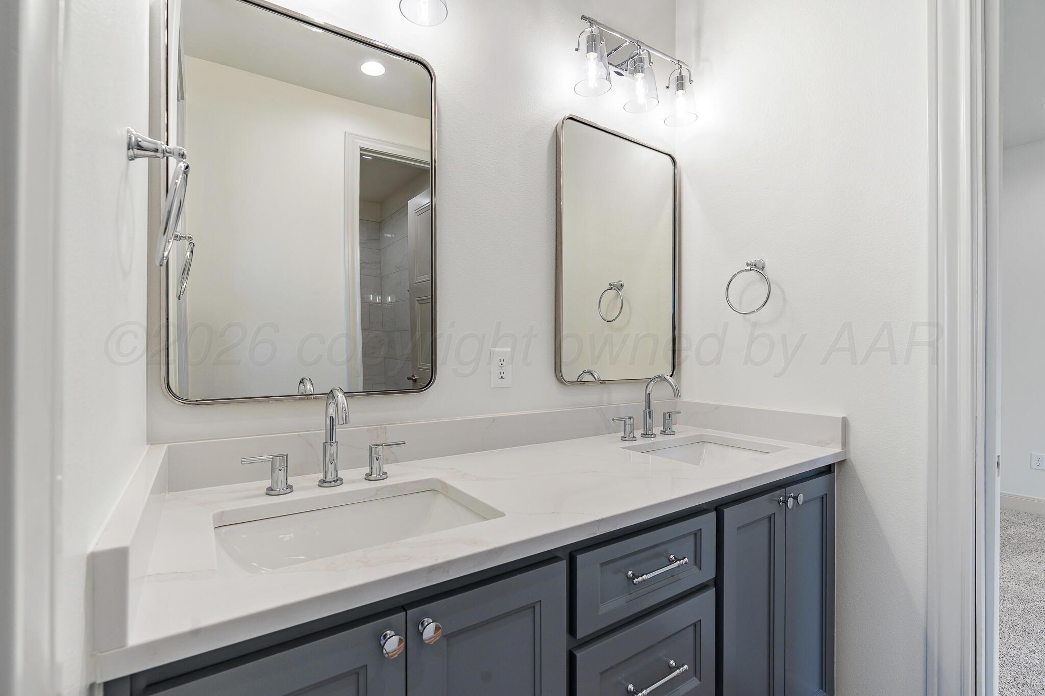 16551 Spring Lake Drive Canyon, TX 79015 - Photo 45 of 60 a bathroom with a double vanity sink and a mirror