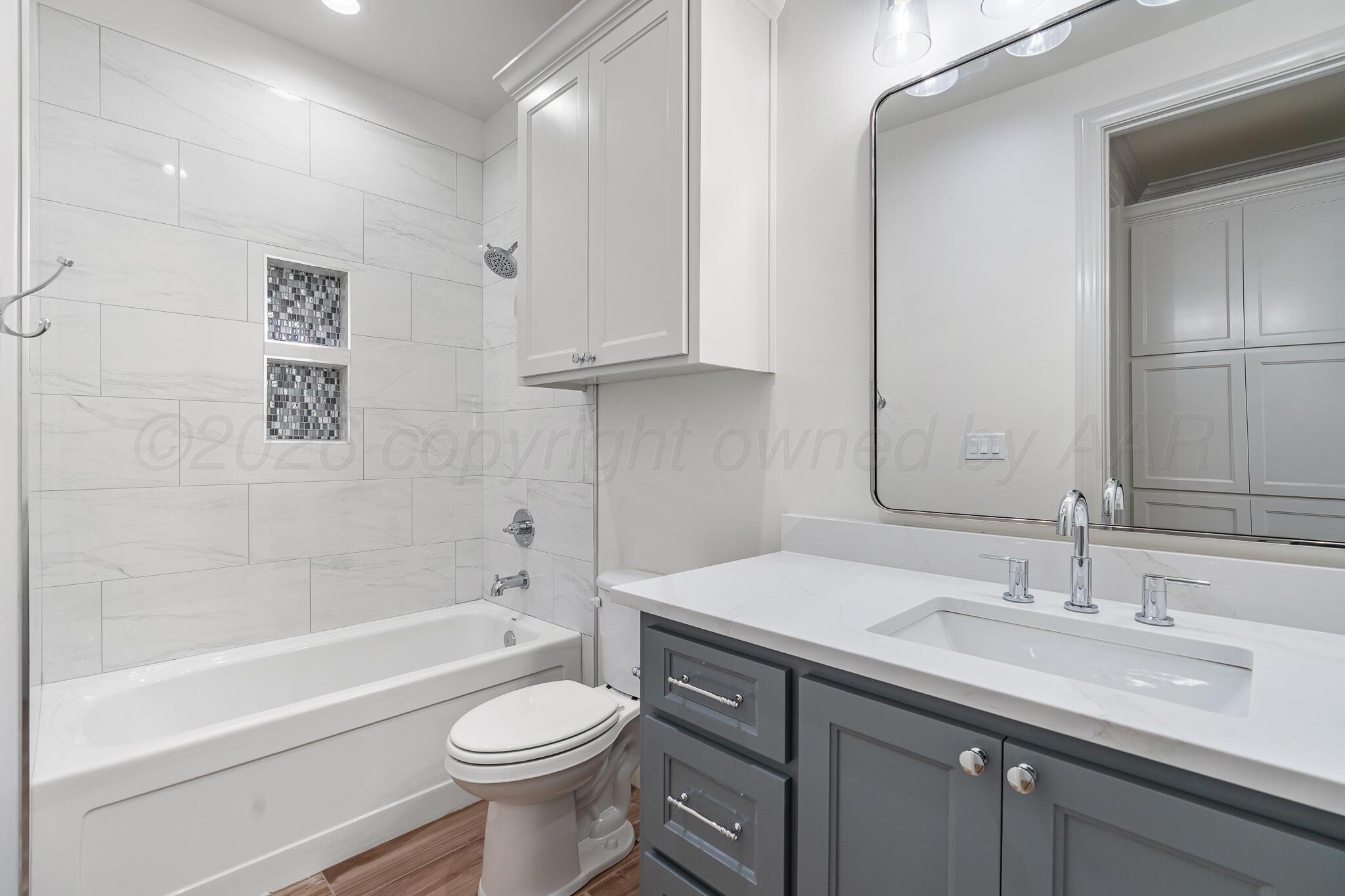 16551 Spring Lake Drive Canyon, TX 79015 - Photo 49 of 60 a bathroom with a sink a toilet and a bathtub