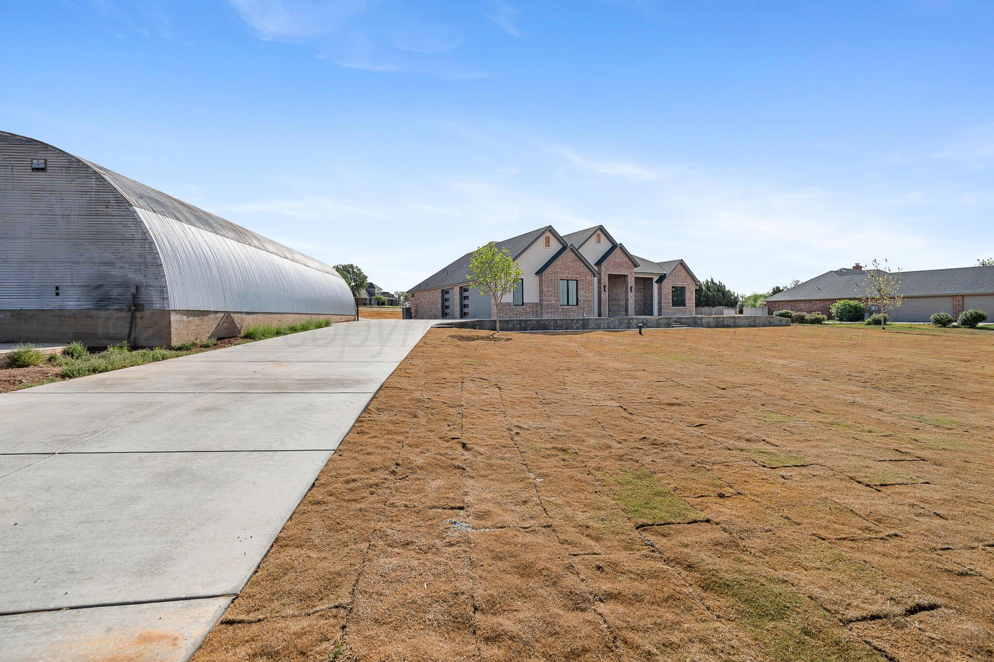 16551 Spring Lake Drive Canyon, TX 79015 - Photo 5 of 60 a view of a brick house with a yard