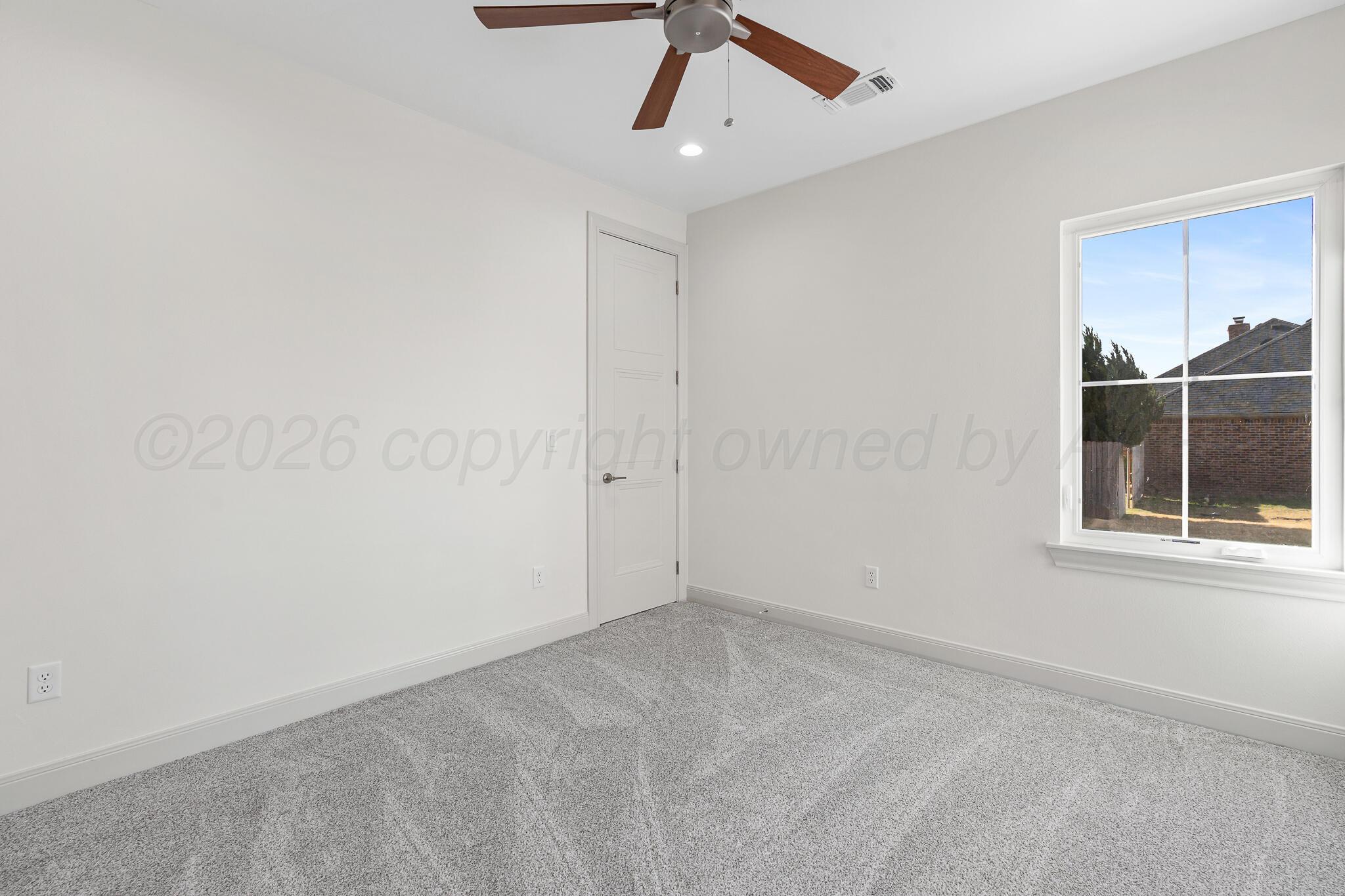 16551 Spring Lake Drive Canyon, TX 79015 - Photo 53 of 60 an empty room with a window and a ceiling fan