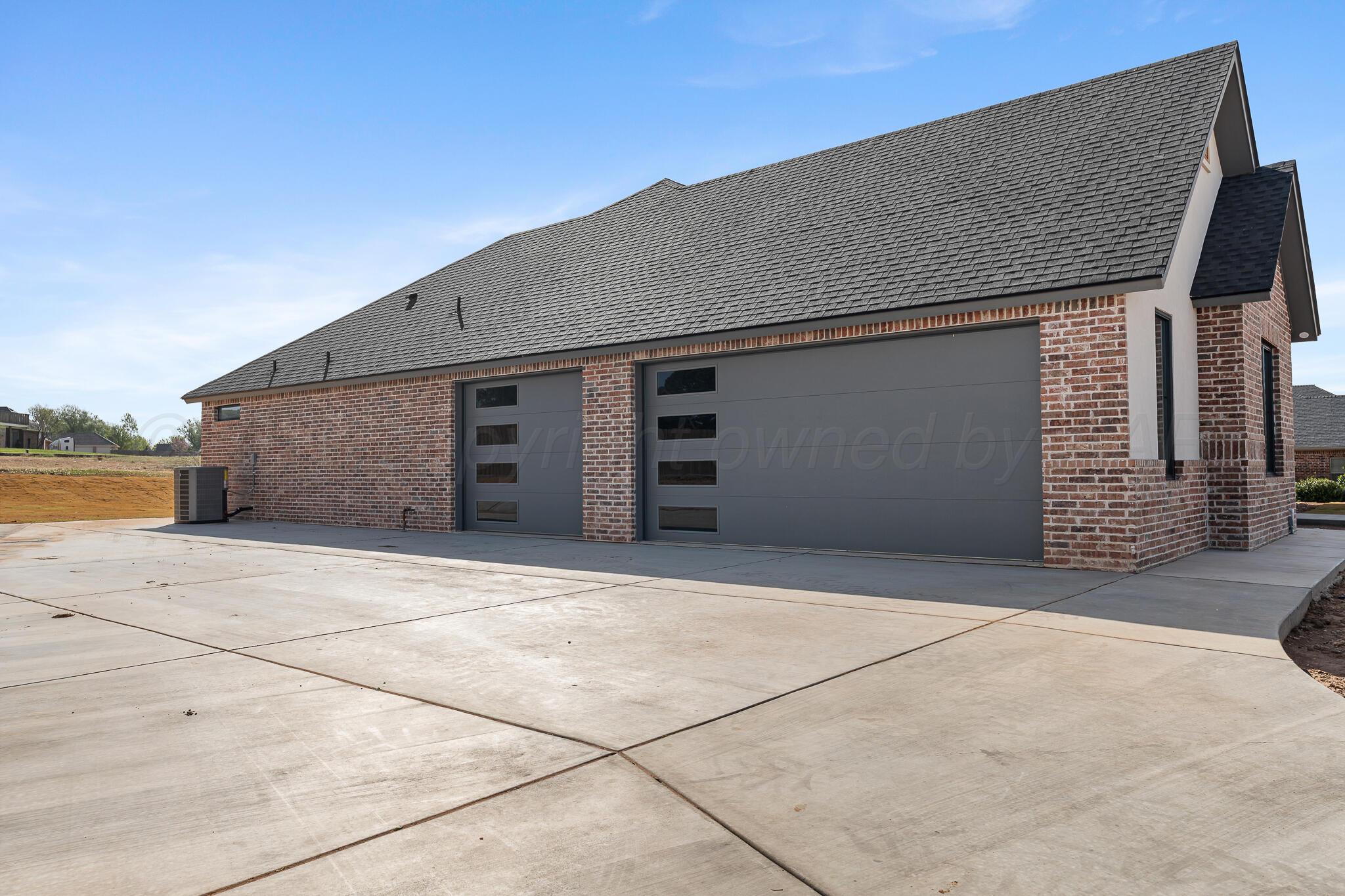 16551 Spring Lake Drive Canyon, TX 79015 - Photo 58 of 60 a front view of a house with garage