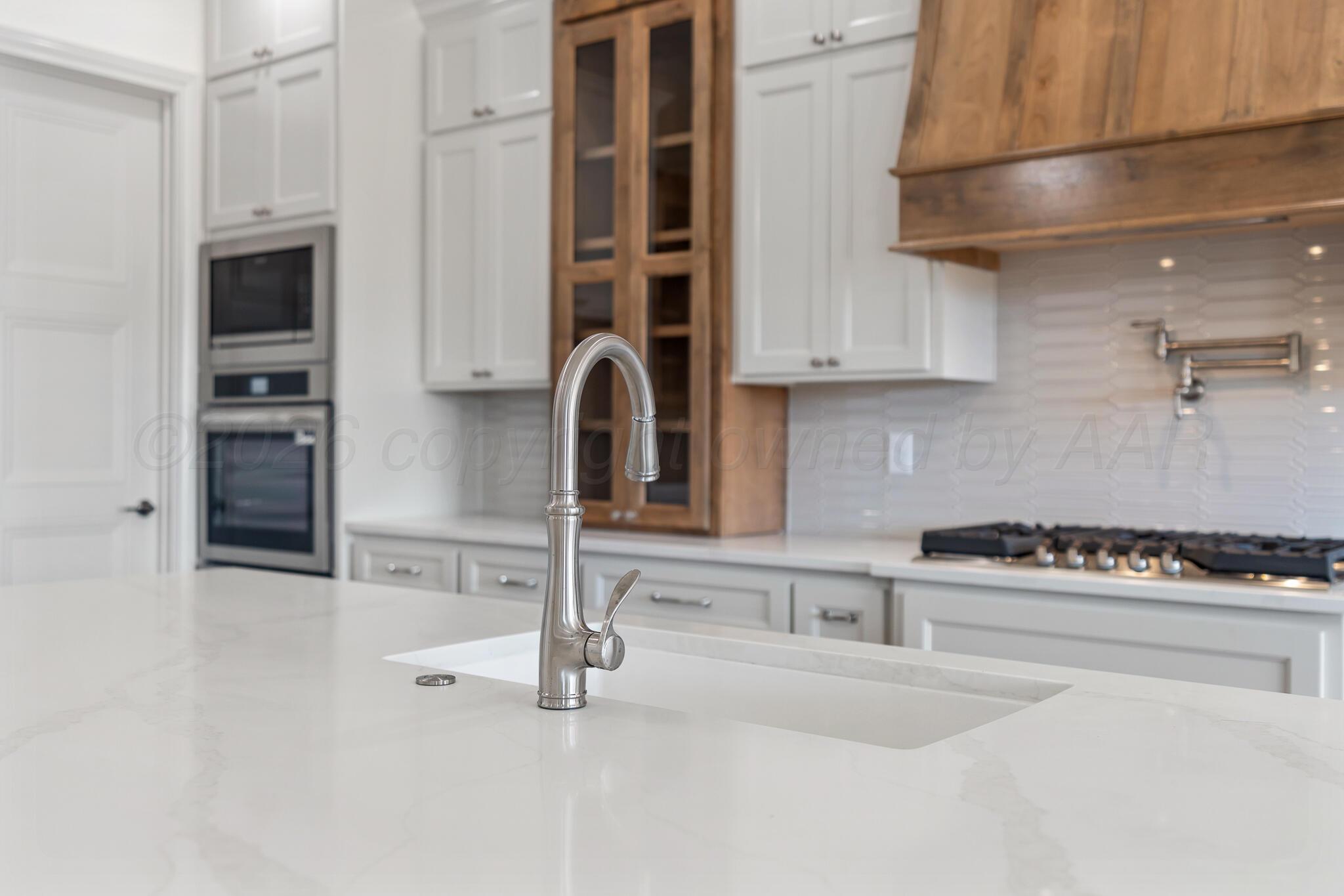 16551 Spring Lake Drive Canyon, TX 79015 - Photo 10 of 60 a kitchen with granite countertop a stove and a sink