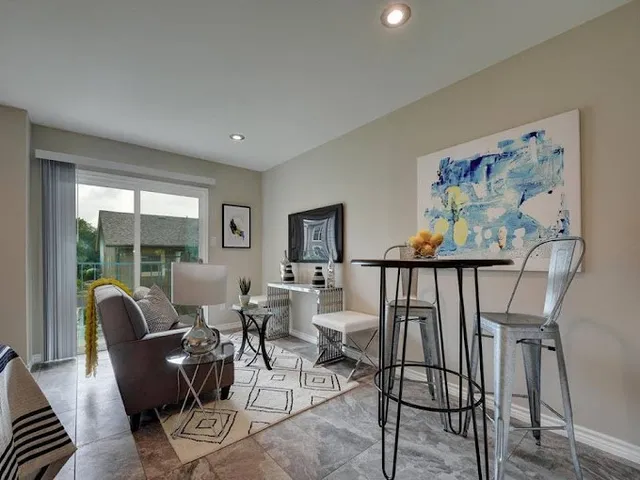 a dining room with furniture a rug and wooden floor