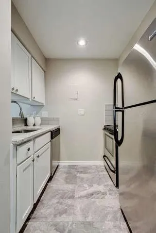 a kitchen with sink and cabinets
