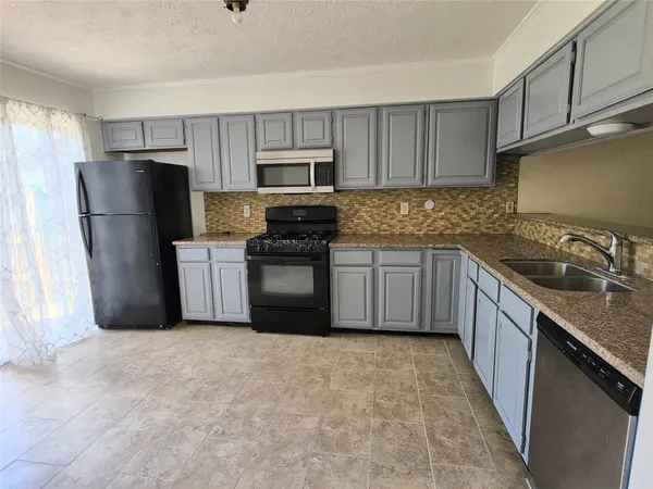 a kitchen with stainless steel appliances granite countertop a refrigerator stove a sink and dishwasher