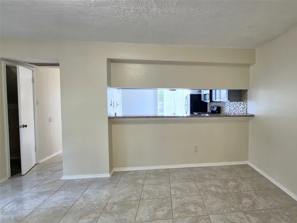 a kitchen with granite countertop a sink and a cabinets