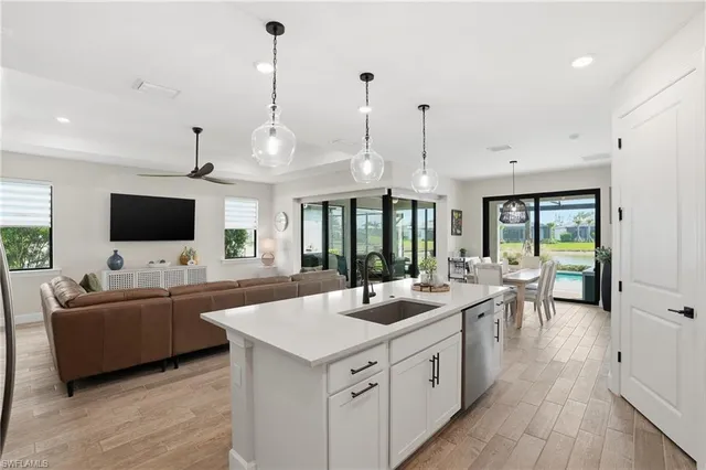 a kitchen with a sink and living room view
