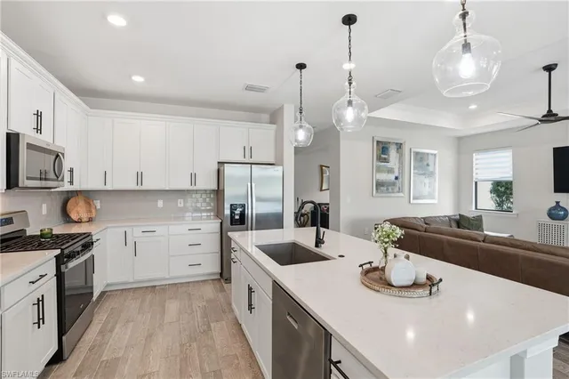 a kitchen with sink stove and cabinets
