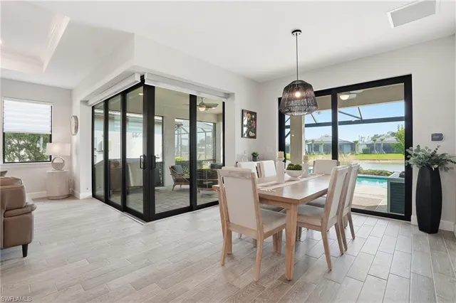 a dining room with furniture a chandelier and fireplace