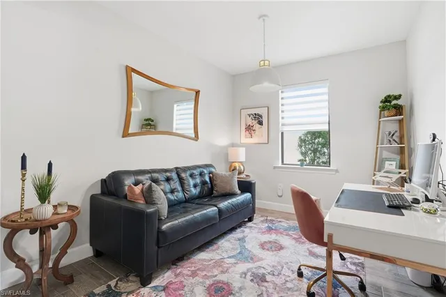 a living room with furniture rug and window