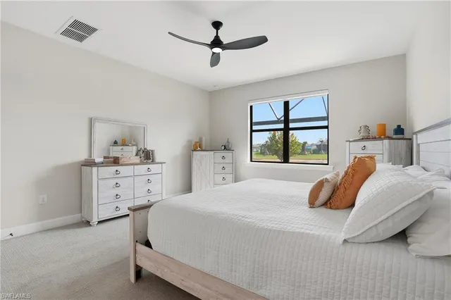 a bedroom with a bed and a large window