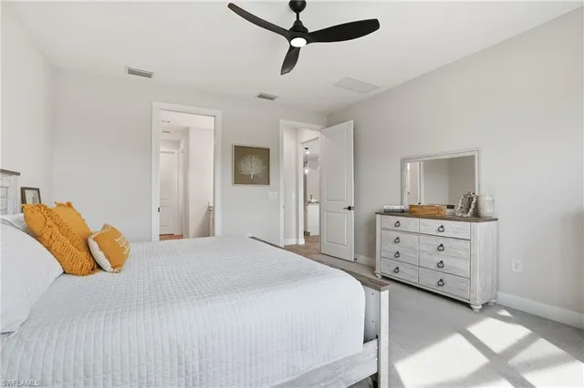 a bedroom with a bed and cabinets