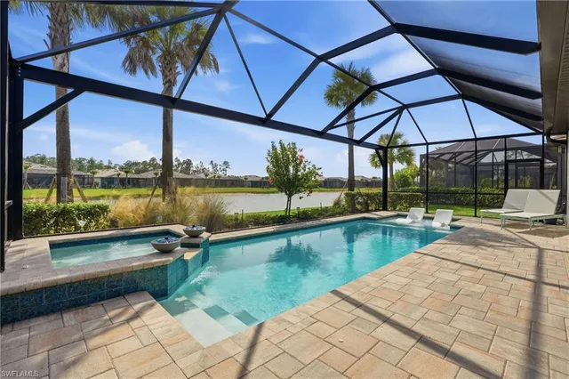 a view of swimming pool with outdoor seating and a yard