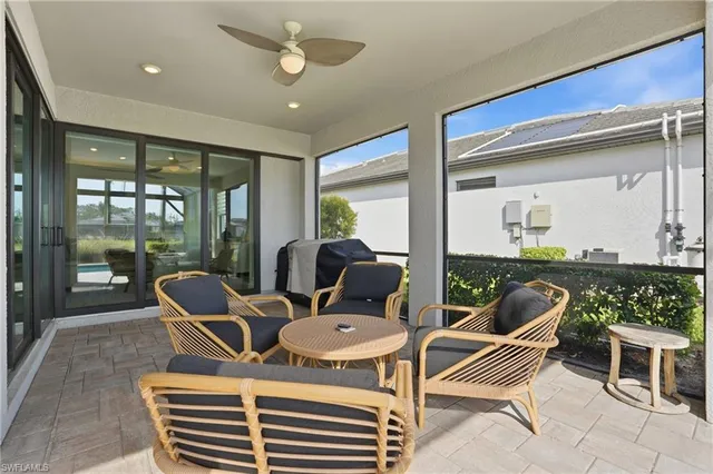 a dining room with furniture and a floor to ceiling window