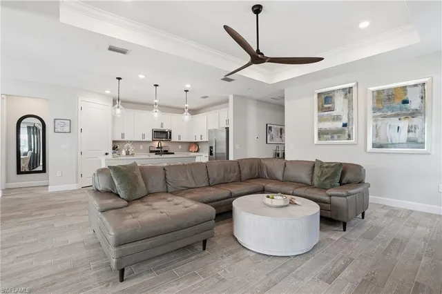a living room with furniture and kitchen view