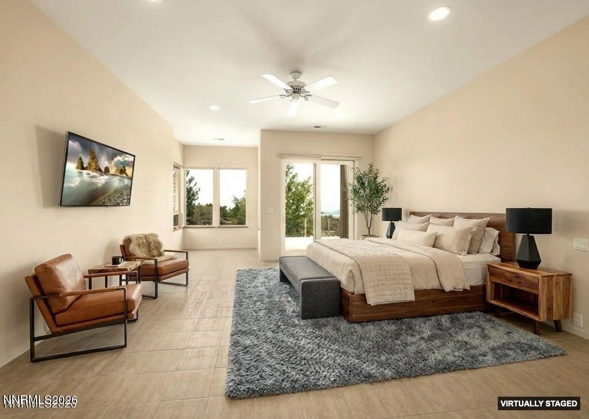 10123 Indian Ridge Drive Reno, NV 89511 - Photo 12 of 33 a spacious bedroom with a bed a couch and large window