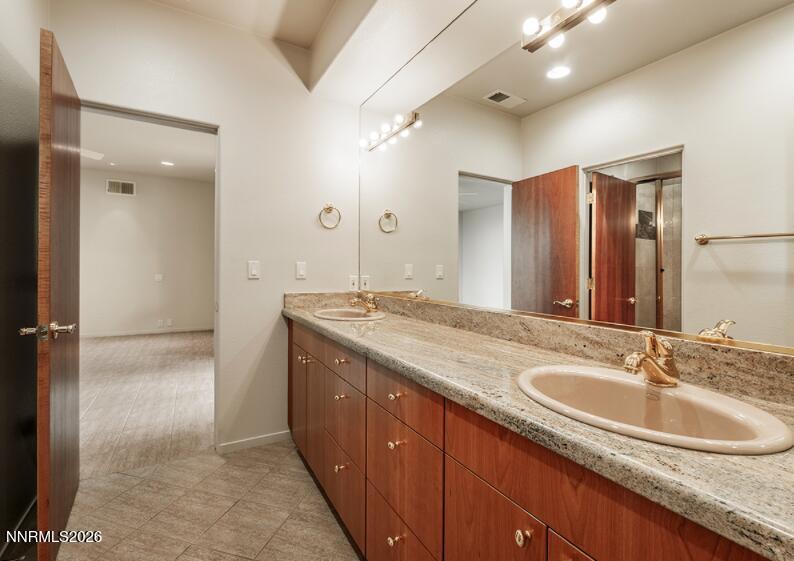 10123 Indian Ridge Drive Reno, NV 89511 - Photo 21 of 33 a bathroom with a granite countertop sink and a mirror