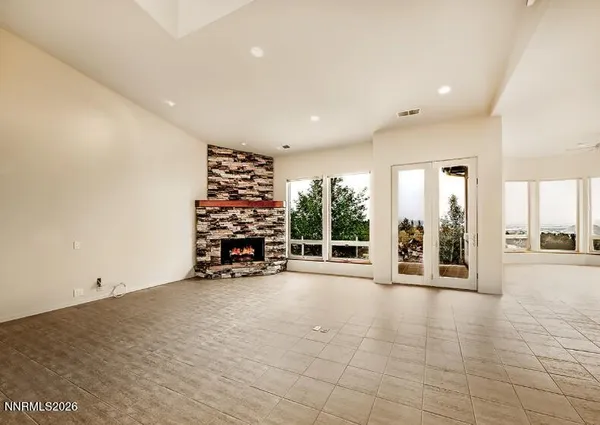 an empty room with furniture and a wooden floor