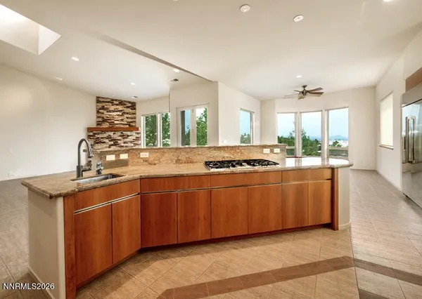 a large kitchen with stainless steel appliances granite countertop a sink and a stove