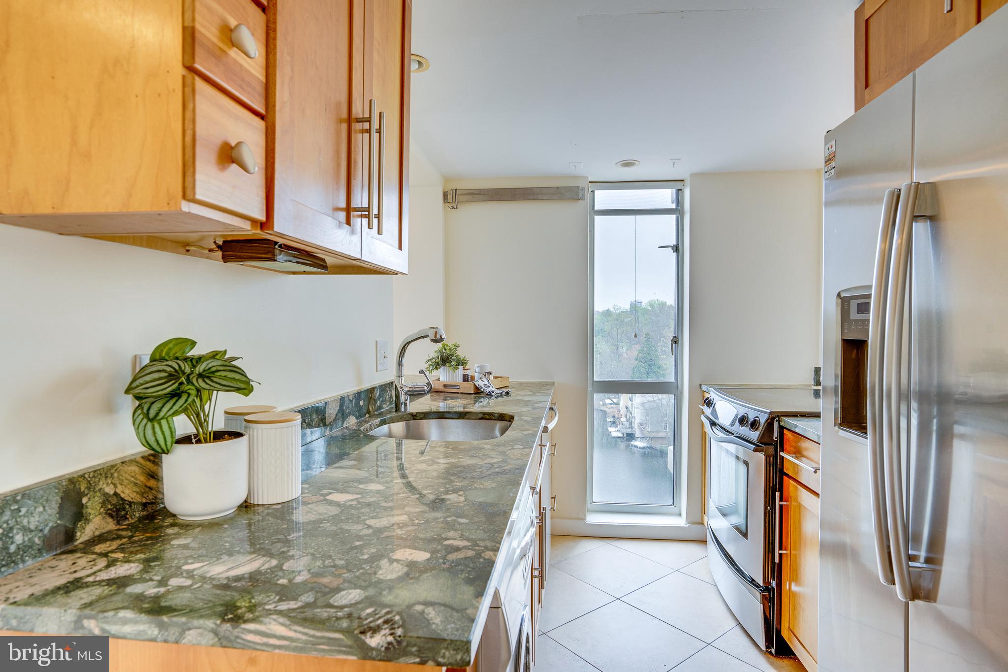 11400 Washington Plaza West, Unit 803 Reston, VA 20190 - Photo 14 of 43 a kitchen with refrigerator and natural light