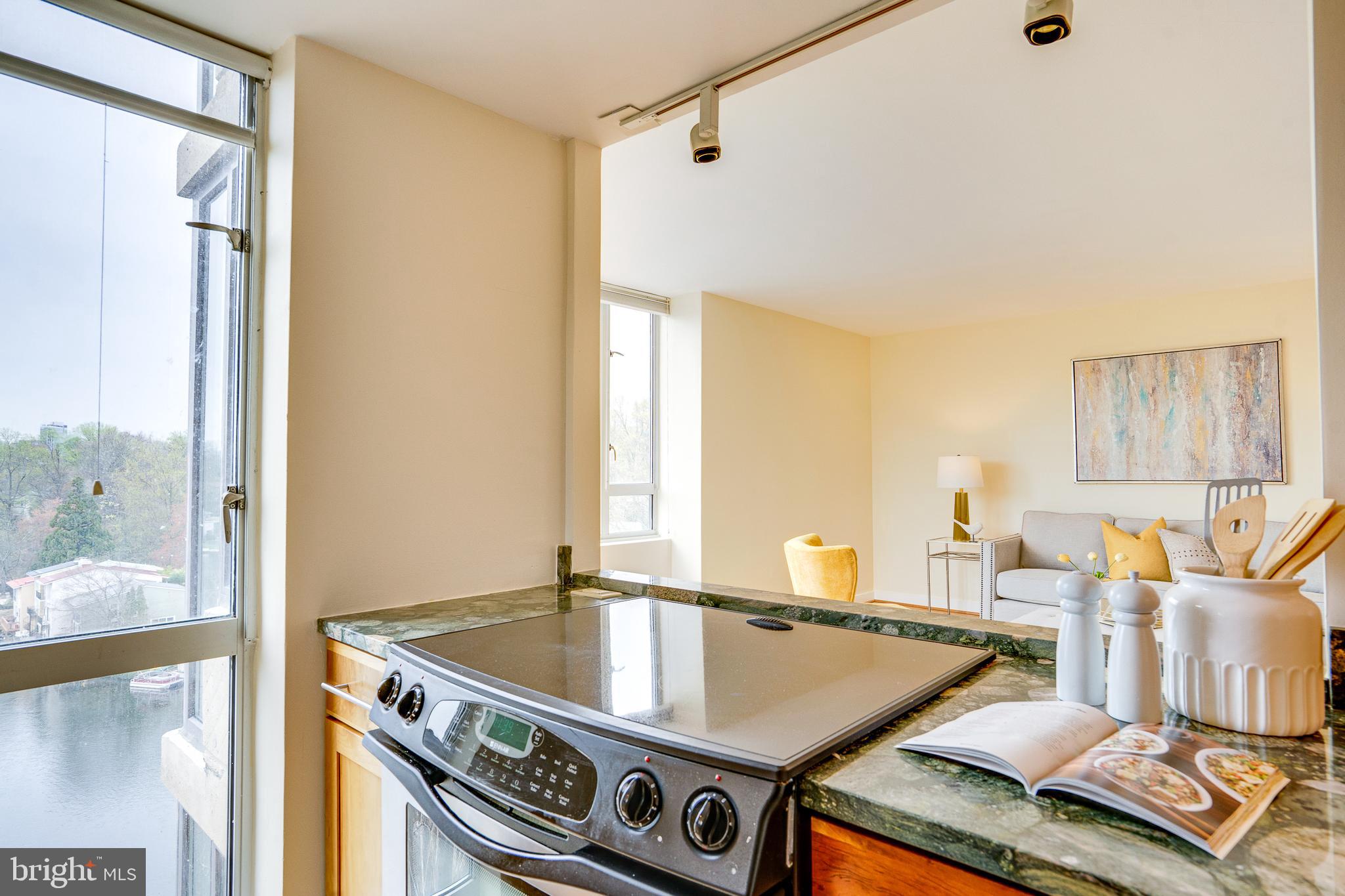 11400 Washington Plaza West, Unit 803 Reston, VA 20190 - Photo 15 of 43 a view of a kitchen with kitchen island a large window cabinets and stainless steel appliances