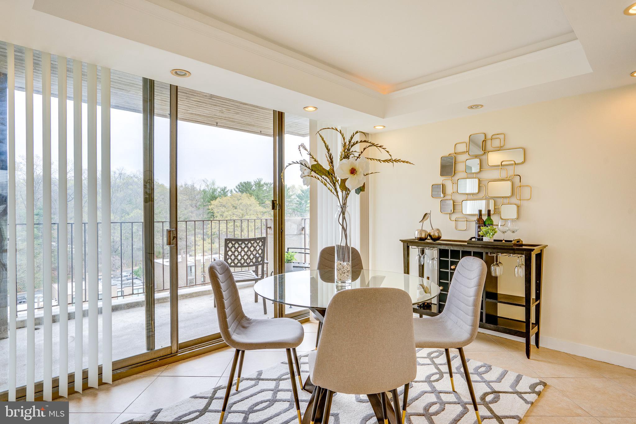 11400 Washington Plaza West, Unit 803 Reston, VA 20190 - Photo 17 of 43 a dining room with furniture a chandelier and wooden floor