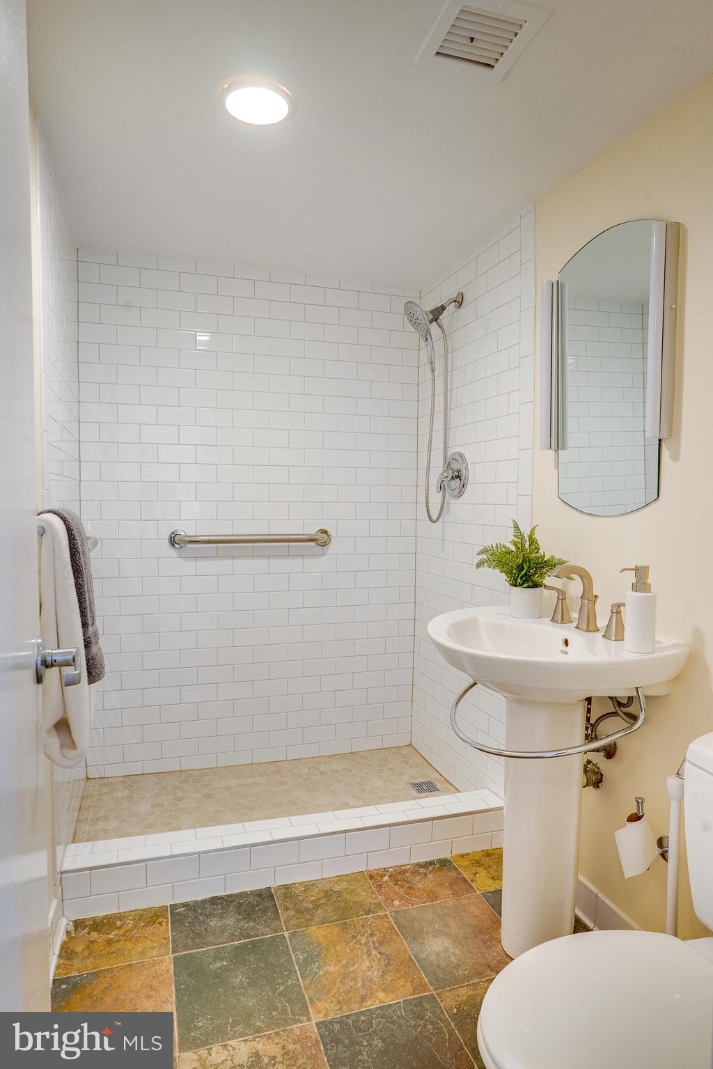 11400 Washington Plaza West, Unit 803 Reston, VA 20190 - Photo 30 of 43 a bathroom with a sink a toilet and shower