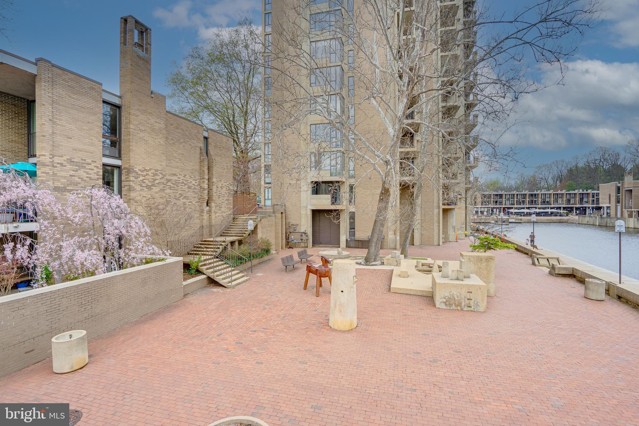 11400 Washington Plaza West, Unit 803 Reston, VA 20190 - Photo 3 of 43 a view of a patio with couches and table under an umbrella