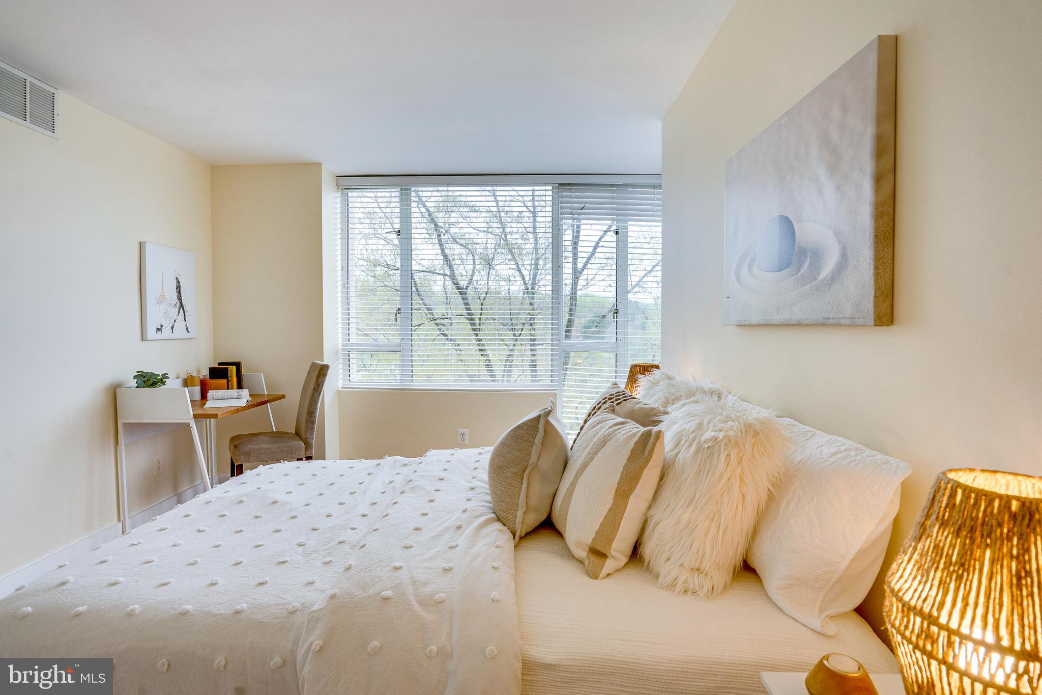 11400 Washington Plaza West, Unit 803 Reston, VA 20190 - Photo 32 of 43 a bedroom with a bed and a large window