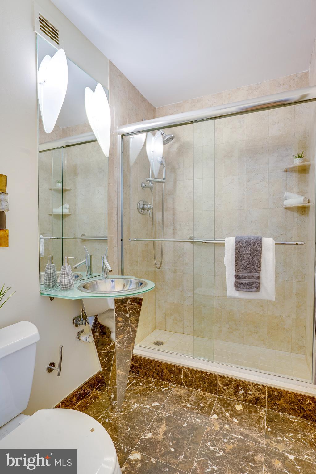 11400 Washington Plaza West, Unit 803 Reston, VA 20190 - Photo 35 of 43 a bathroom with a sink a toilet and shower