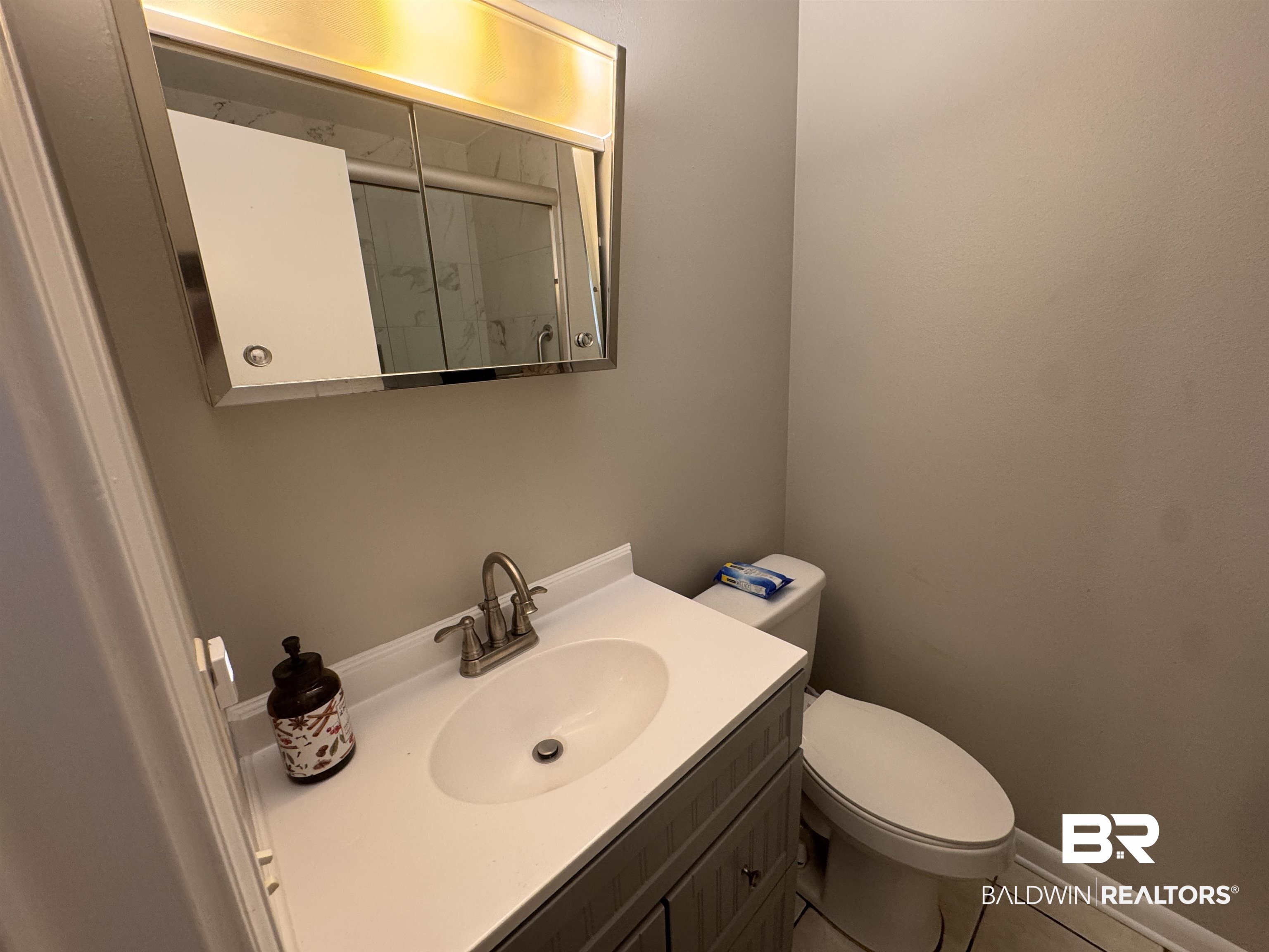15148 Highland Circle Foley, AL 36535 - Photo 26 of 47 Full bath featuring toilet, vanity, tile patterned flooring, and a shower