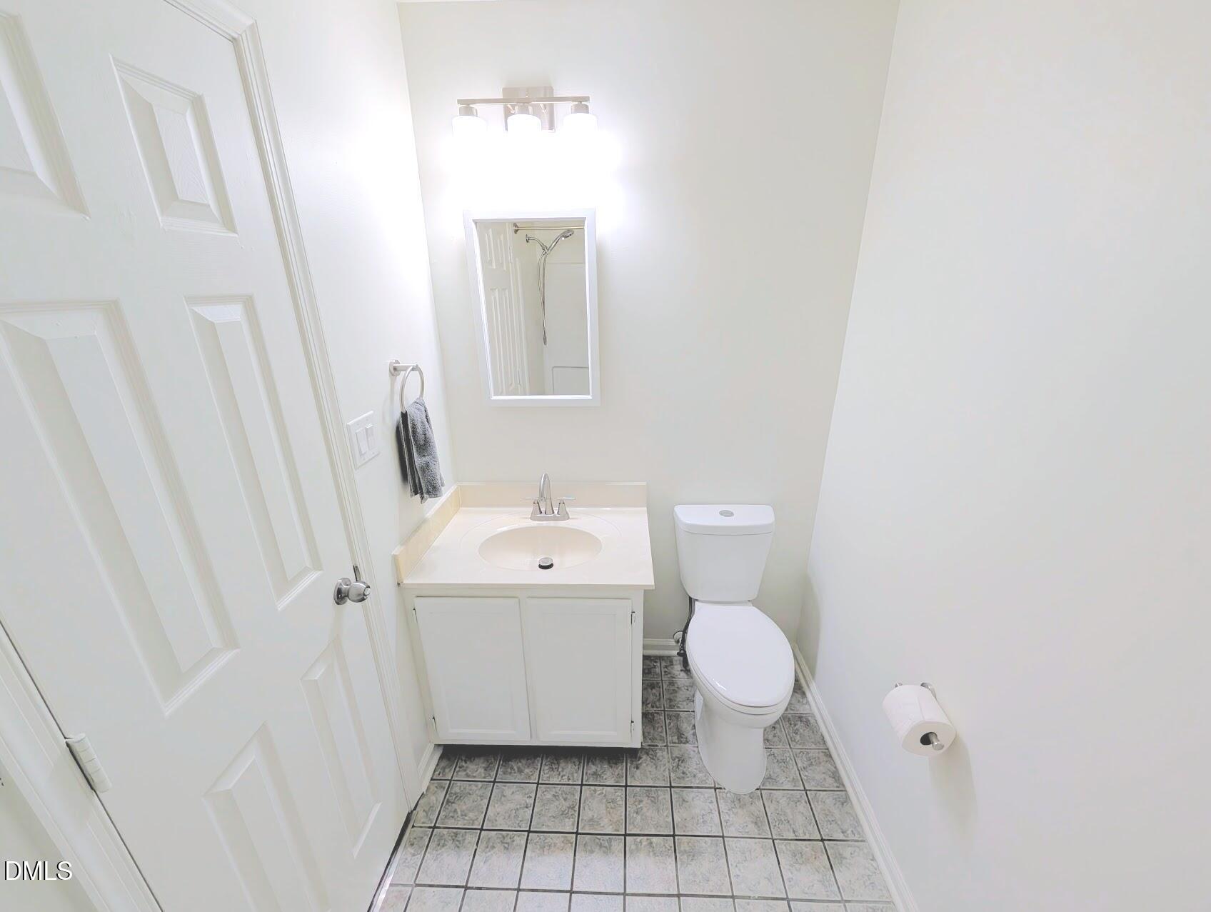 2020 Quaker Landing, Unit 103 Raleigh, NC 27603 - Photo 12 of 19 a bathroom with a sink toilet and shower