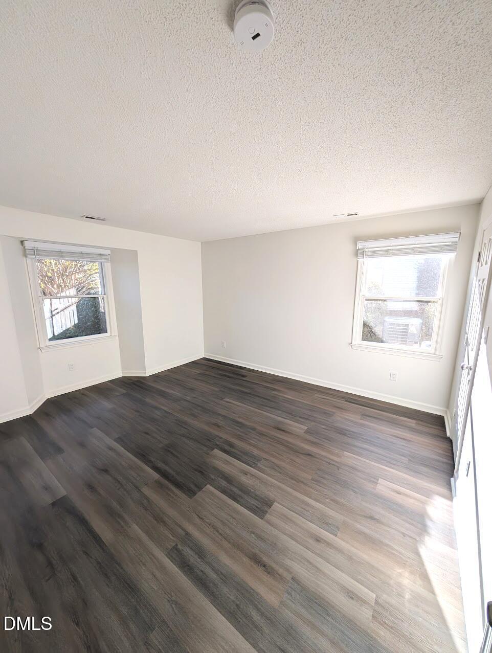 2020 Quaker Landing, Unit 103 Raleigh, NC 27603 - Photo 14 of 19 a view of empty room with wooden floor and fan