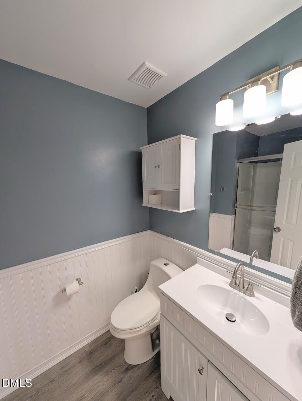 2020 Quaker Landing, Unit 103 Raleigh, NC 27603 - Photo 17 of 19 a bathroom with a toilet sink and mirror