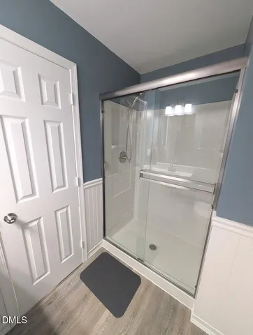 a bathroom with a glass door shower