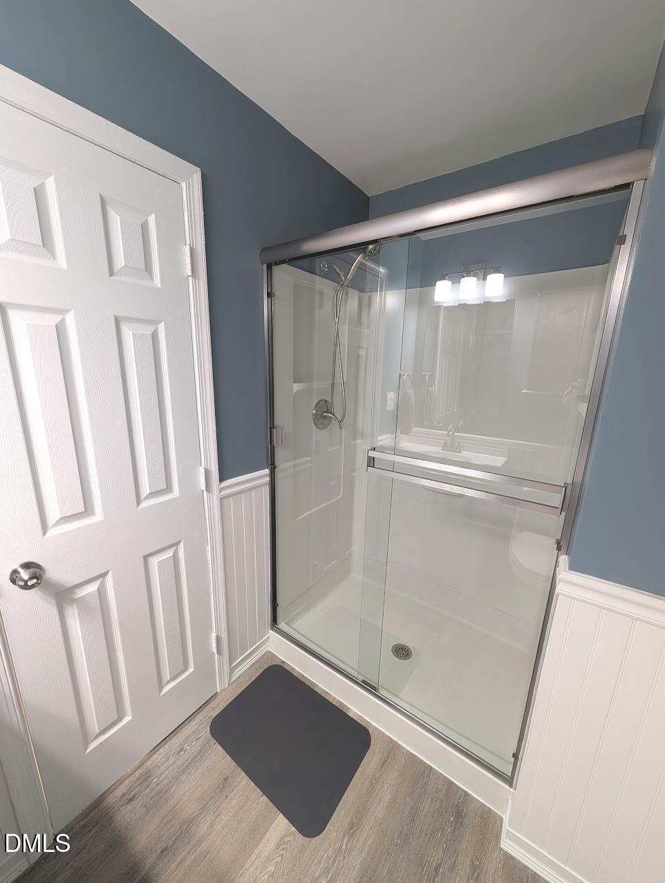 2020 Quaker Landing, Unit 103 Raleigh, NC 27603 - Photo 18 of 19 a bathroom with a glass door shower