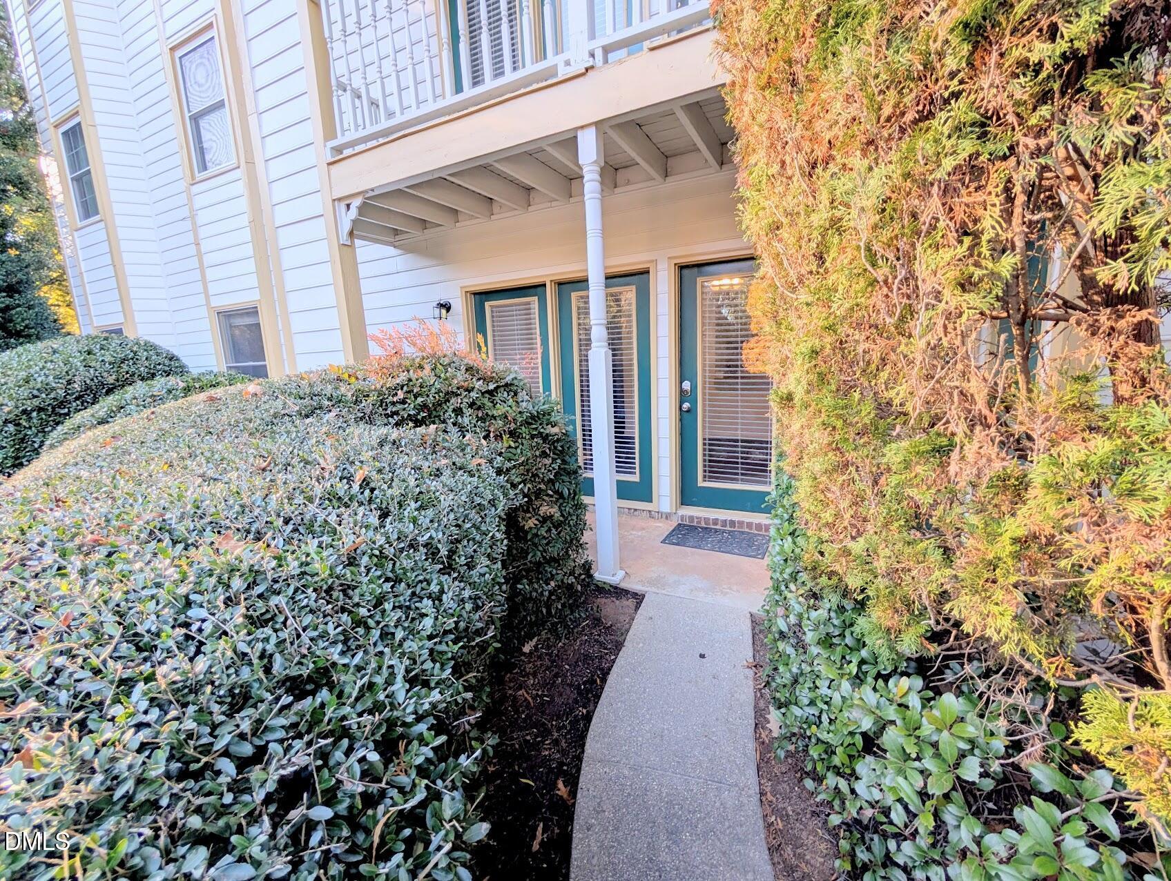 2020 Quaker Landing, Unit 103 Raleigh, NC 27603 - Photo 2 of 19 front view of a house with a garden