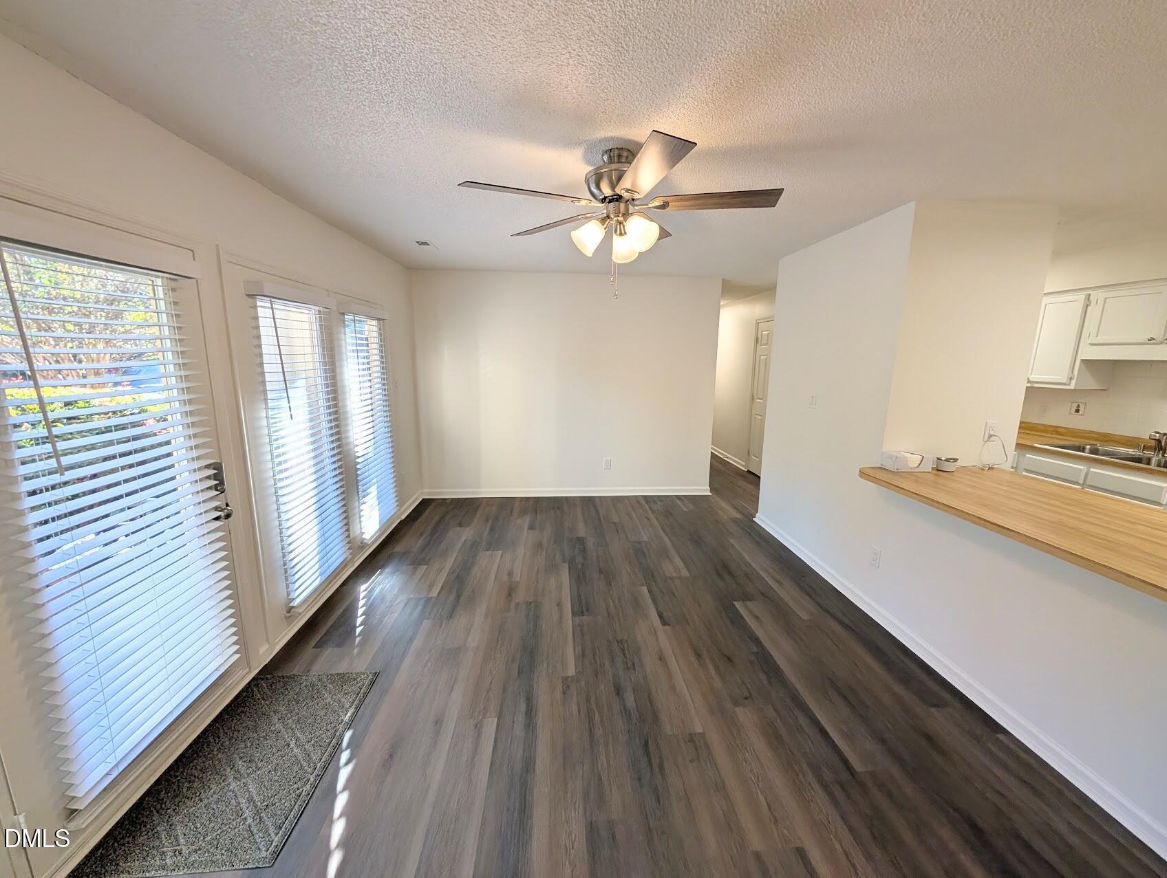 2020 Quaker Landing, Unit 103 Raleigh, NC 27603 - Photo 4 of 19 wooden floor in an empty room with a window