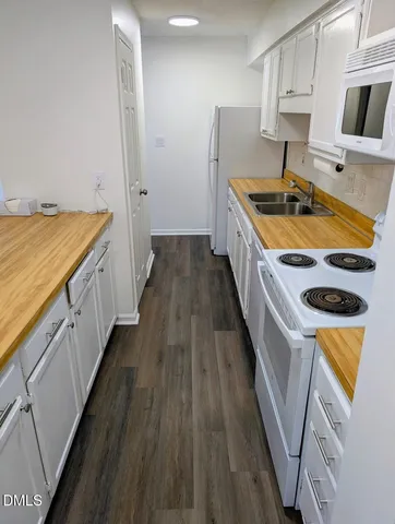 a kitchen with sink stove and refrigerator