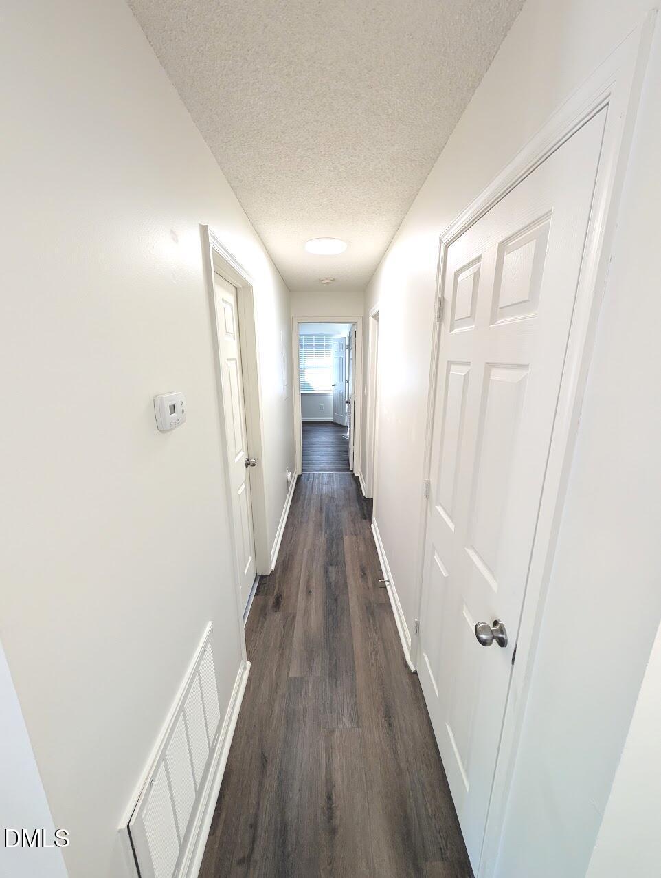 2020 Quaker Landing, Unit 103 Raleigh, NC 27603 - Photo 7 of 19 a view of a hallway with wooden floor
