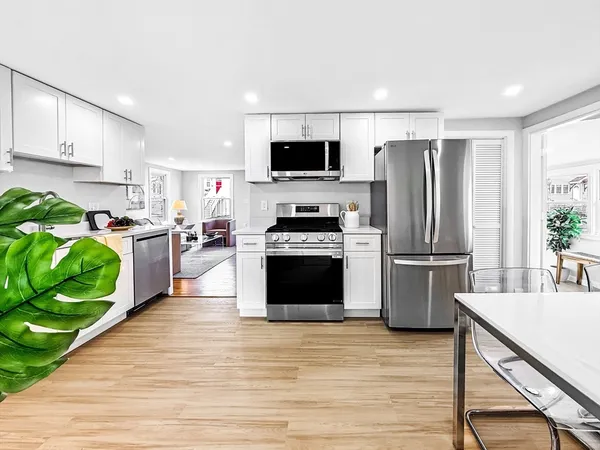 a kitchen with a stove a sink and a microwave