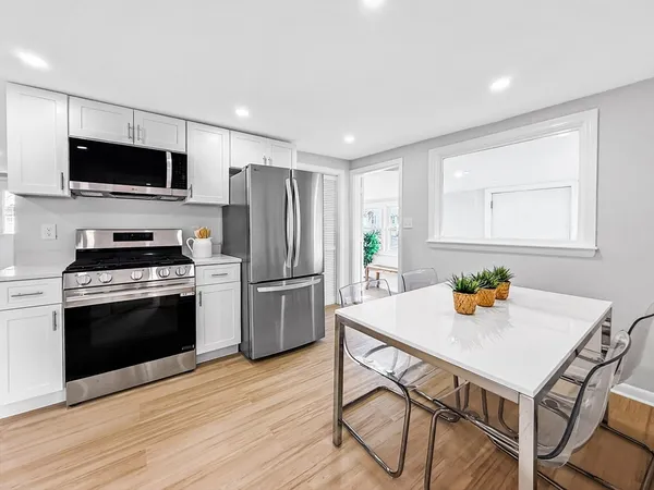a kitchen with cabinets and wooden floor
