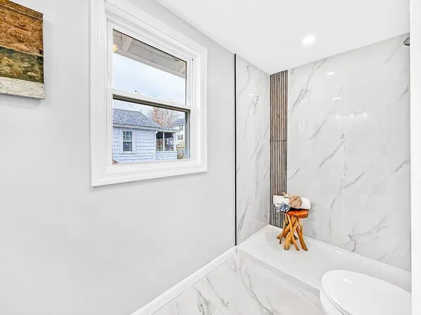 a bathroom with a sink vanity mirror and toilet