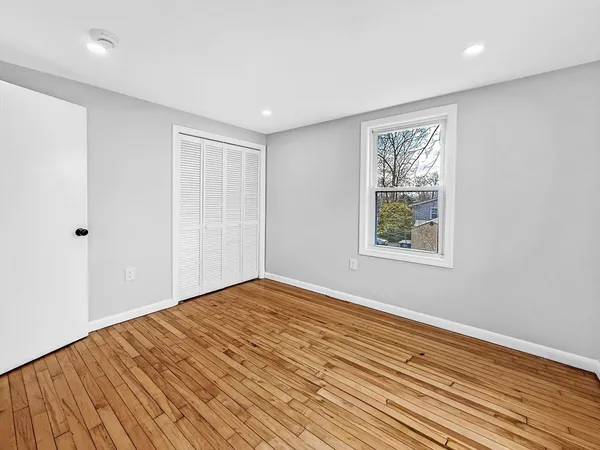 a view of a room with wooden floor and window