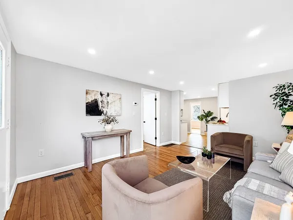 a living room with furniture and wooden floor